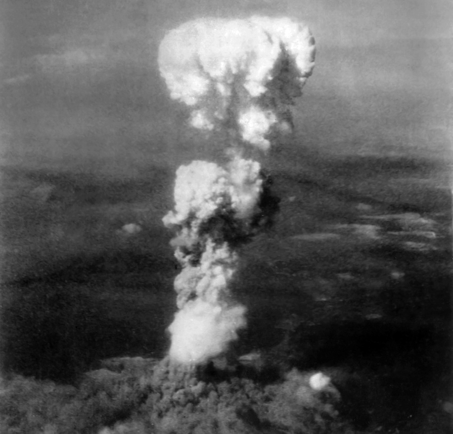 Photographed by a reconnaissance B-29 after detonation, Little Boy’s mushroom cloud towers over the ruins of the Japanese city of Hiroshima on 6 August 1945.